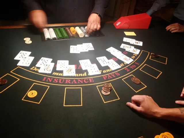 Blackjack table with cards and chips being dealt