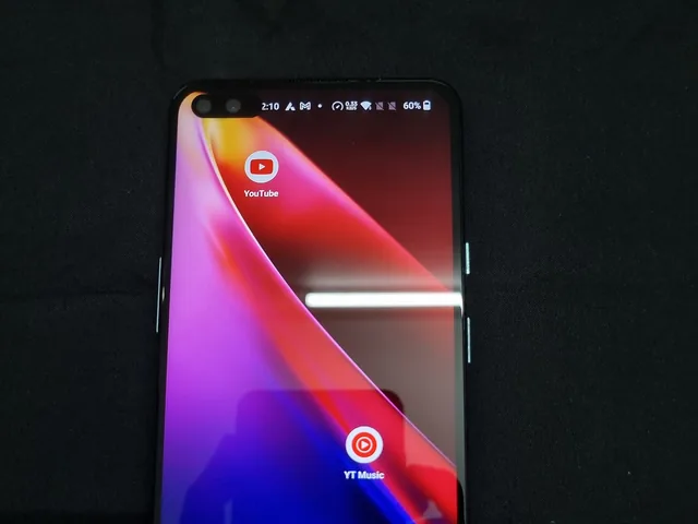 Android smartphone with a colourful home screen on a dark background