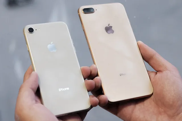 Two iPhones held in hand, seen from the back