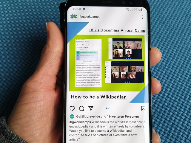 Hand holding a smartphone with a web page open