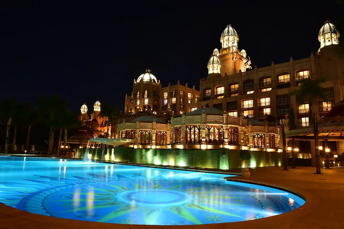Sun City resort lit up at night beside its pool, North West province