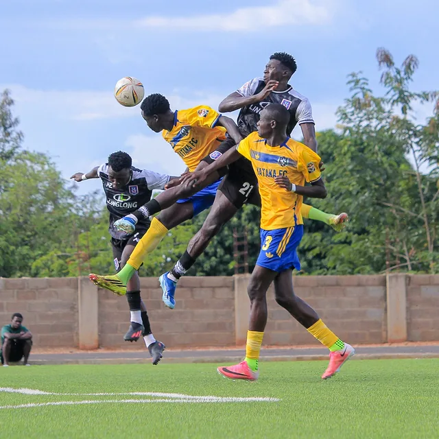 Players challenging for a header in a soccer match