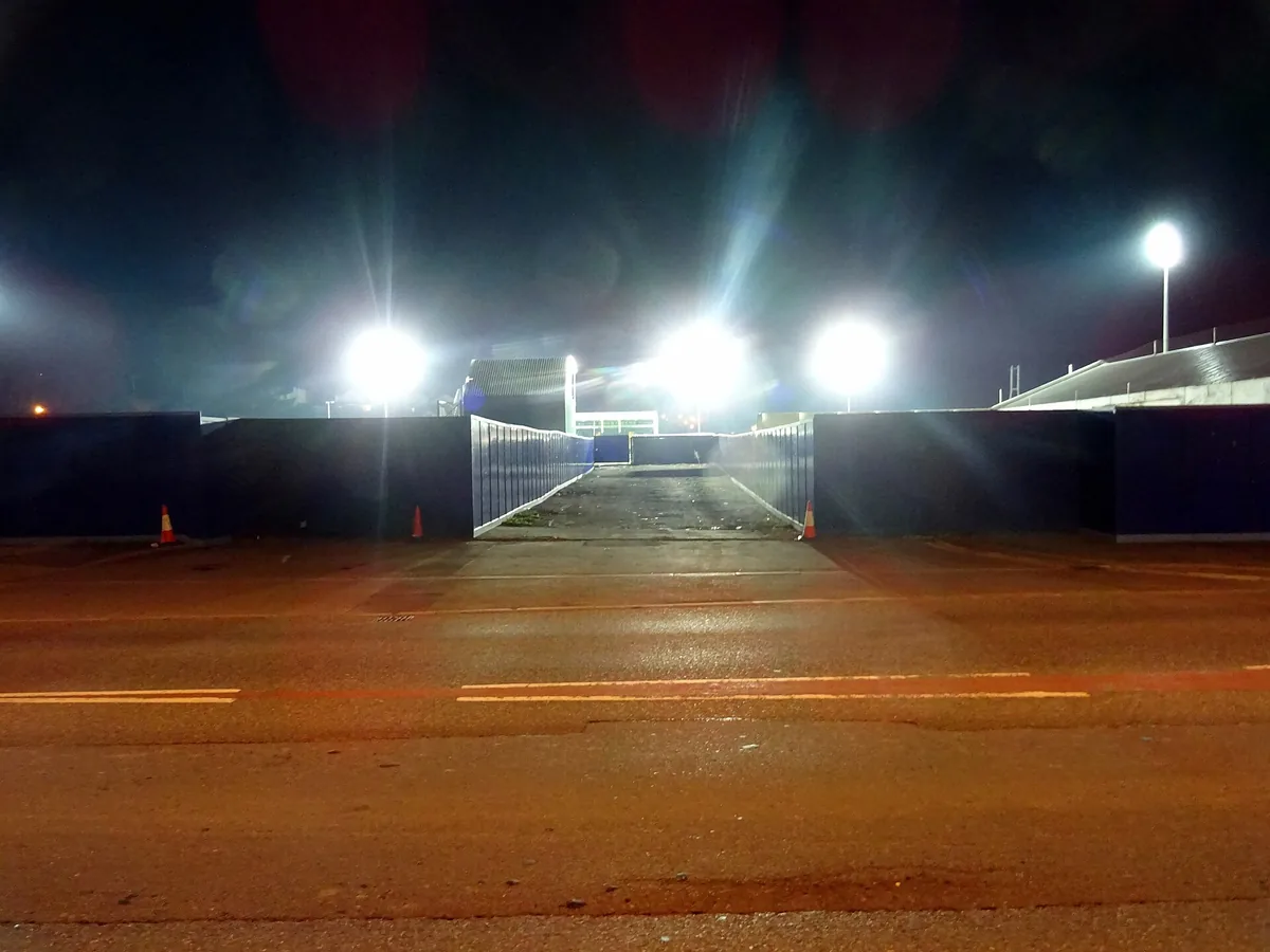 Stadium floodlights switched on at night