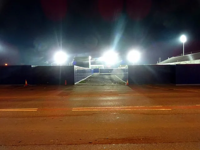 Stadium floodlights switched on at night